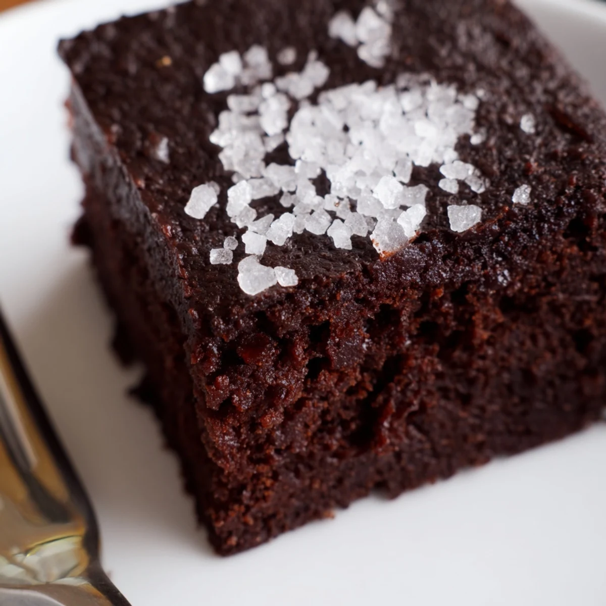 Perfectly baked Chocolate Fudge Brownies with Sea Salt on a rustic wooden cutting board.