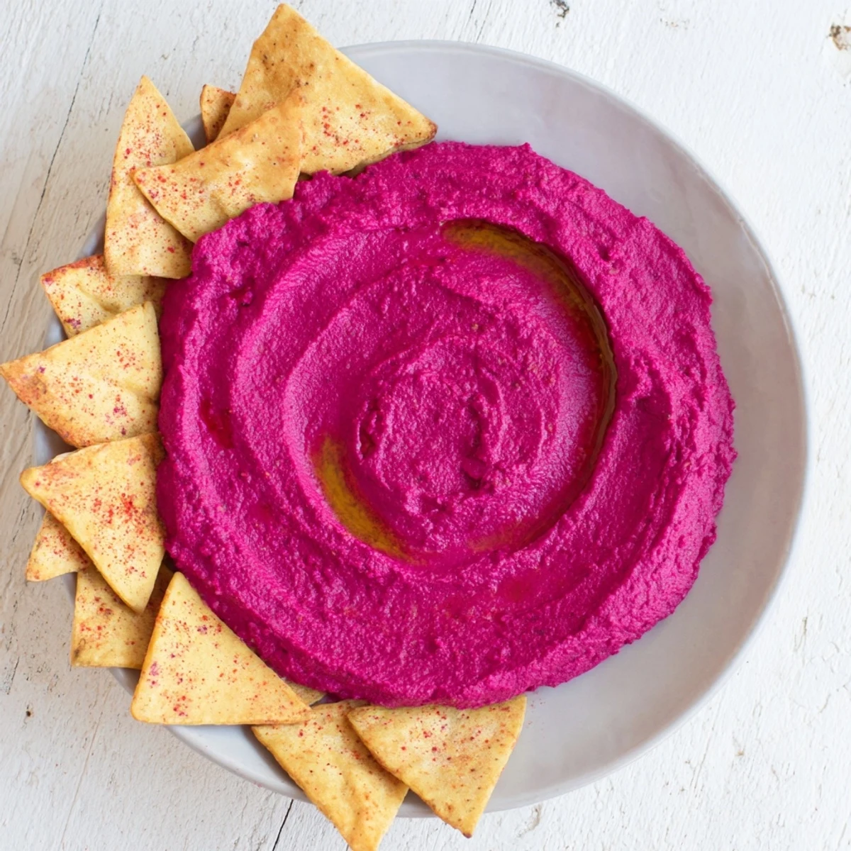 A food processor blends roasted beets and chickpeas for this Roasted Beet Hummus, creating a smooth, creamy texture for dipping.