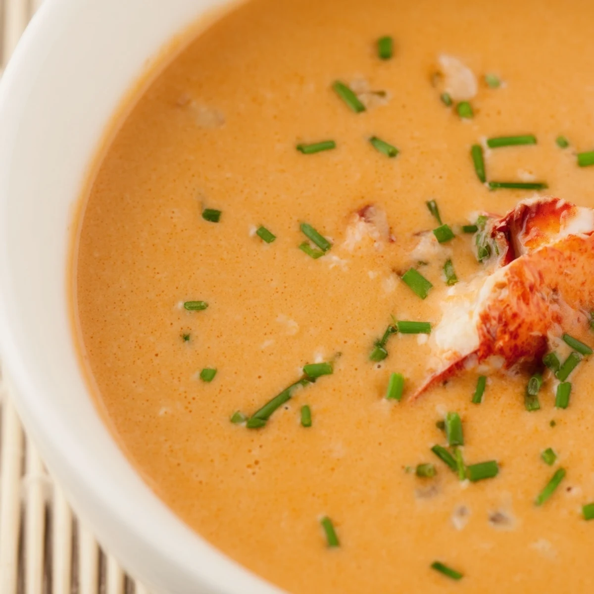 Rich Romantic Lobster Bisque with Sherry Vinegar served steaming in a white bowl, perfect for a cozy dinner.