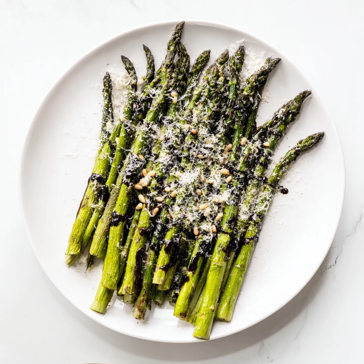 Tender roasted asparagus with balsamic glaze served warm alongside grilled chicken for a healthy spring dinner side dish.