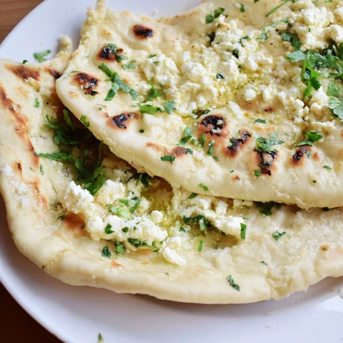 Freshly baked Cottage Cheese Garlic Naan with a soft, pillowy texture and melted garlic butter, perfect for tearing and dipping into flavorful sauces.