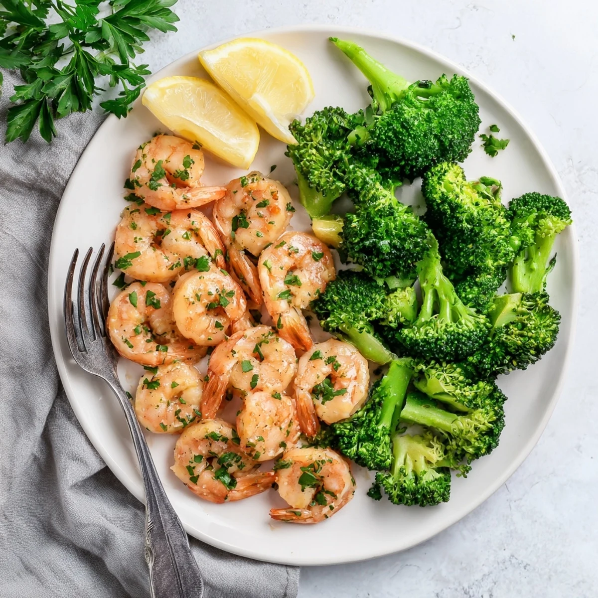 Serving suggestion for Honey Garlic Butter Shrimp & Broccoli, garnished with fresh parsley and lemon wedges, perfect for a weeknight dinner.