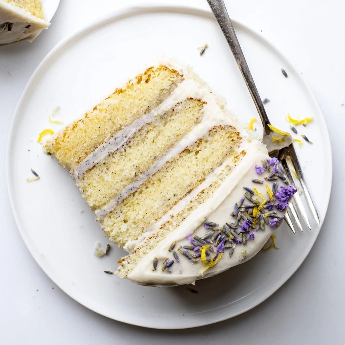 Elegant London Fog Cake with Earl Grey & Lavender displayed on a plate, ready to serve with a hot latte.