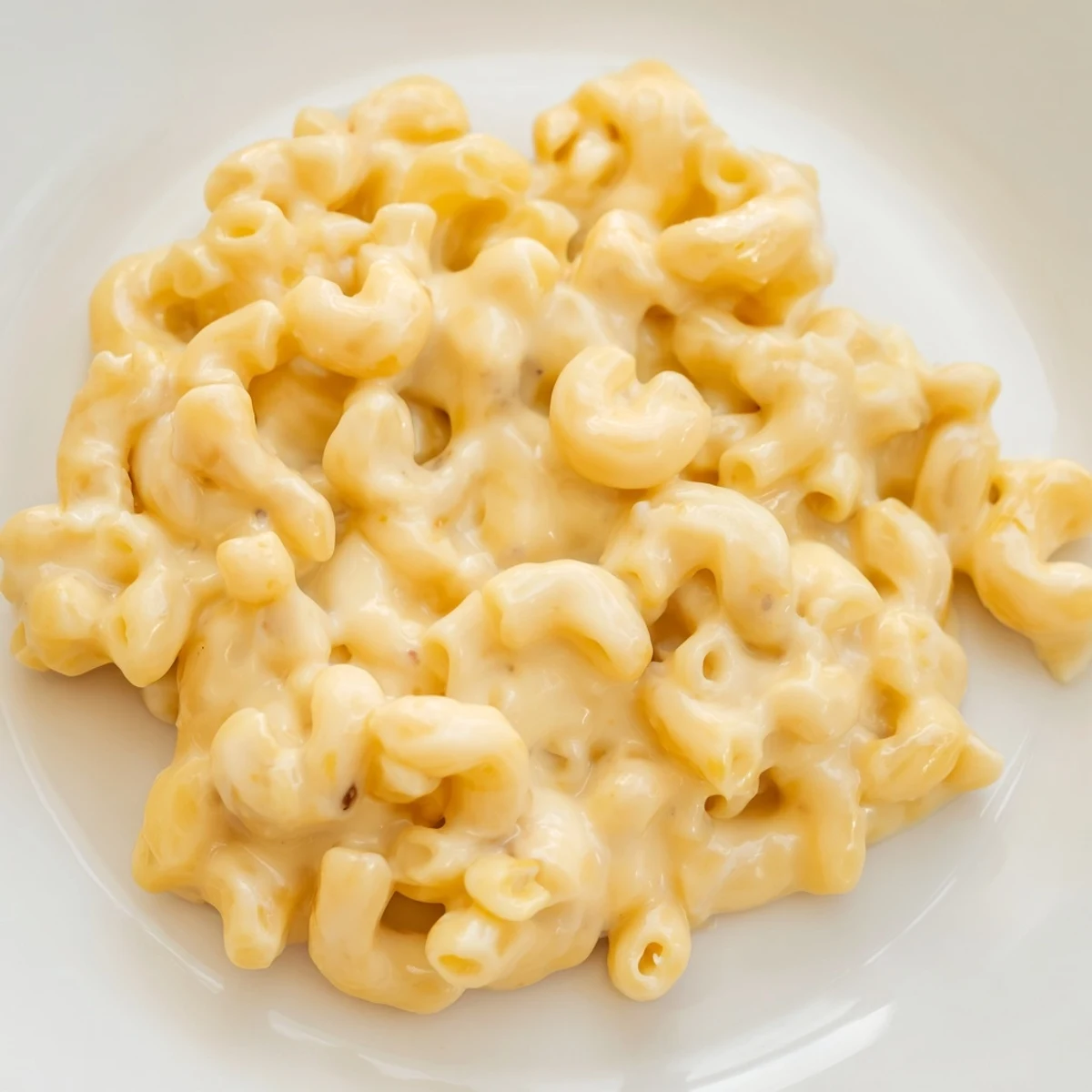 Creamy Boursin mac and cheese with golden breadcrumb topping bubbling in a white baking dish