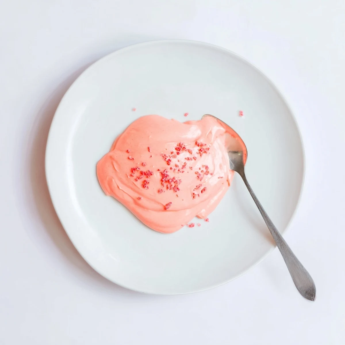 Creamy pink lemon curd with smooth, glossy texture in a glass jar