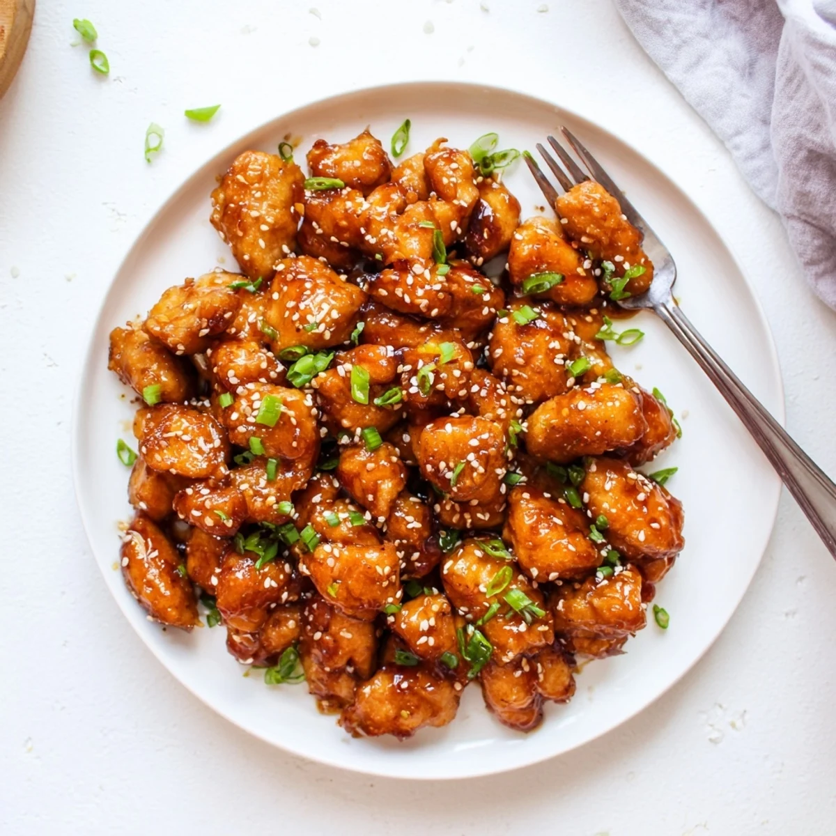 Weeknight honey garlic chicken dinner plated with glossy caramelized sauce and sesame topping