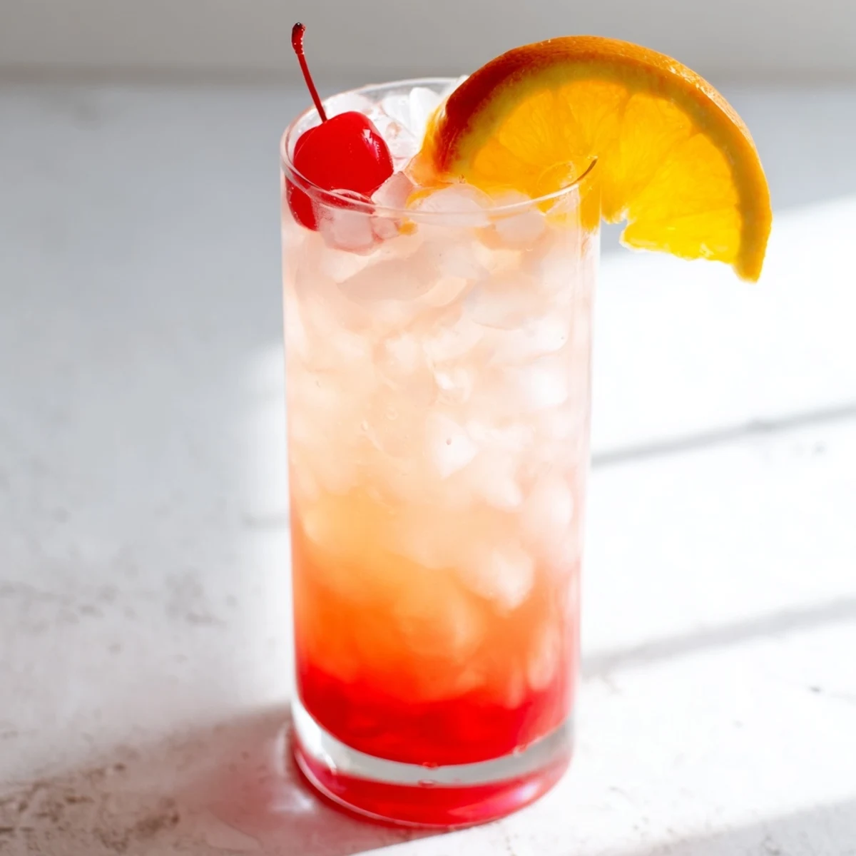Classic Easy Shirley Temple Drink poured over ice with citrus slice and cherry garnish