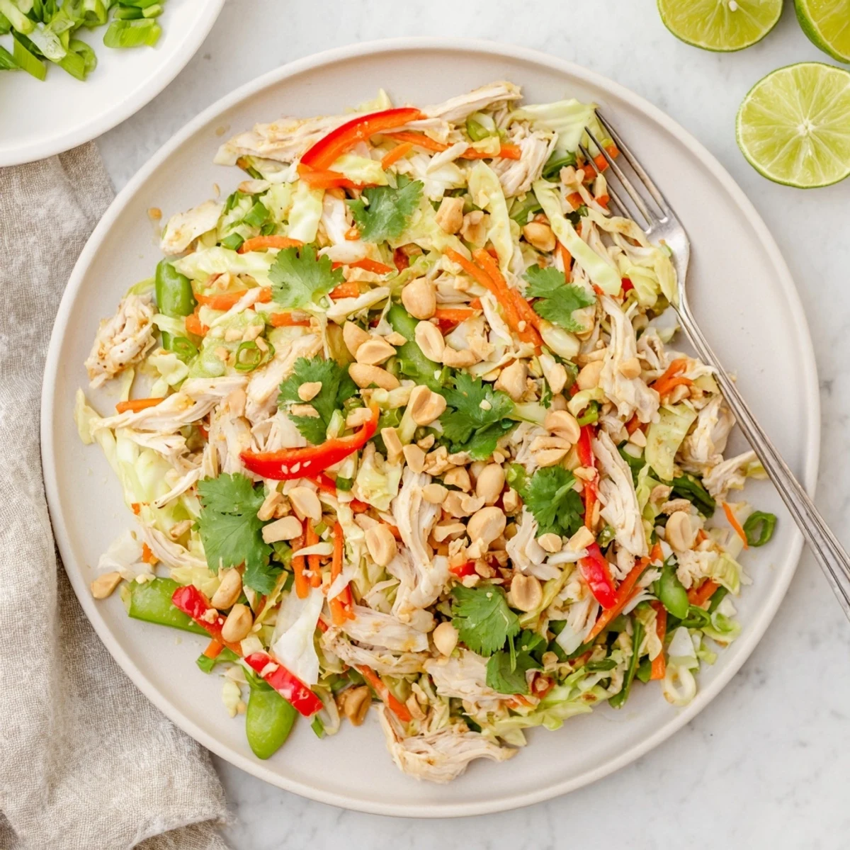 Protein-packed no cook Asian chicken salad with snap peas, bell peppers, and tangy sesame lime dressing.