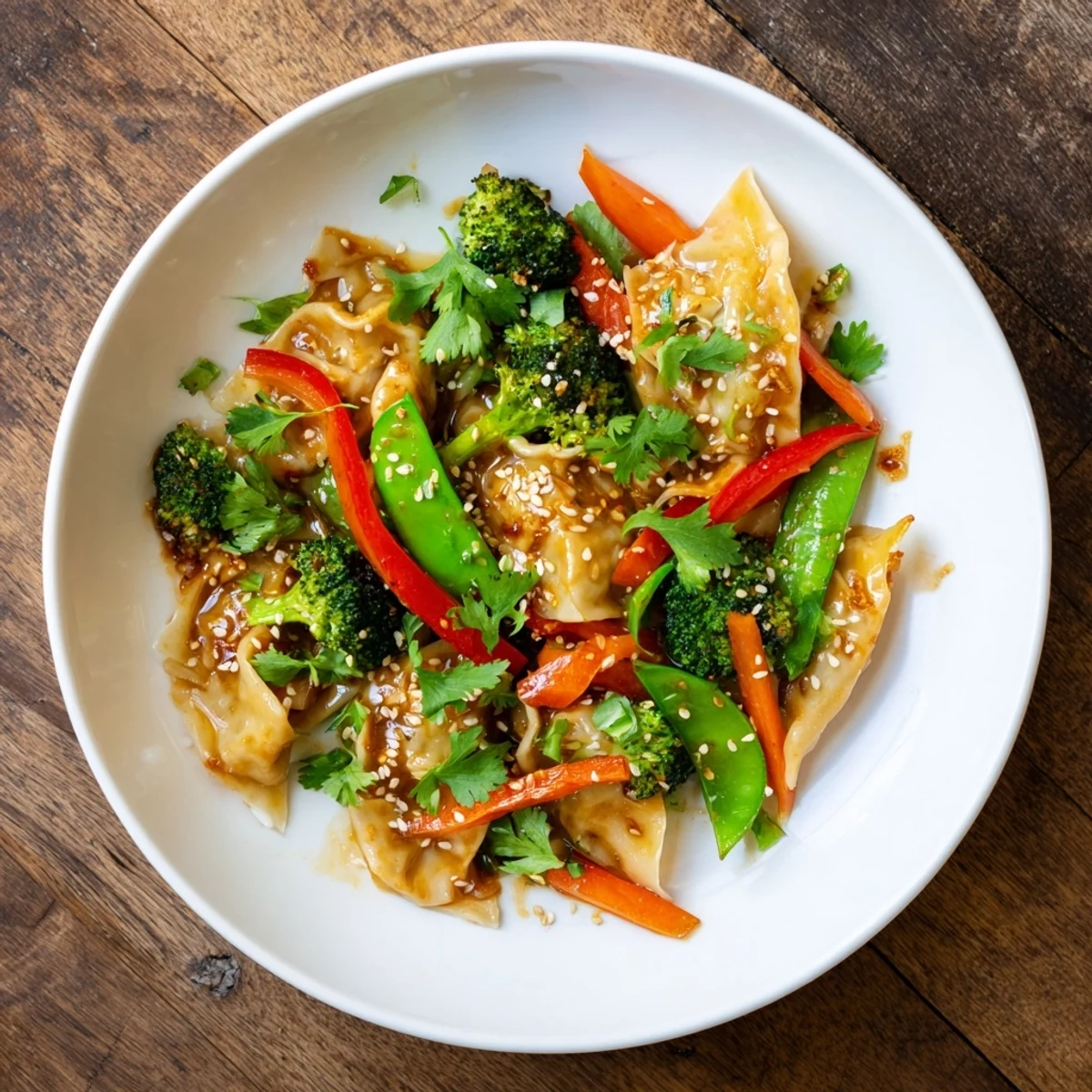 Tender dumplings tossed with crisp broccoli and bell peppers in rich Asian garlic sauce