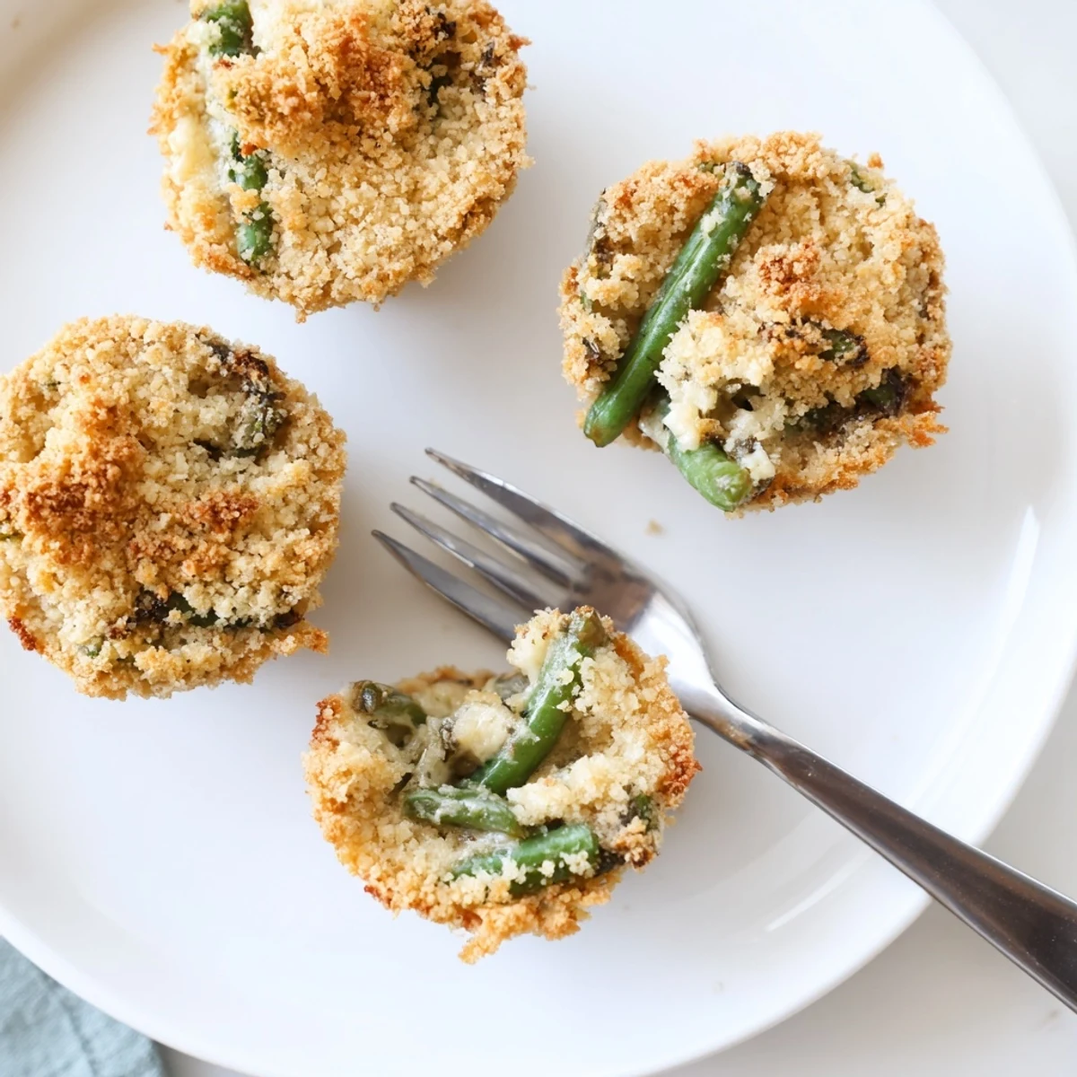 Baked Garlic Parmesan Green Bean Casserole Cups arranged on serving platter with golden breadcrumb garnish