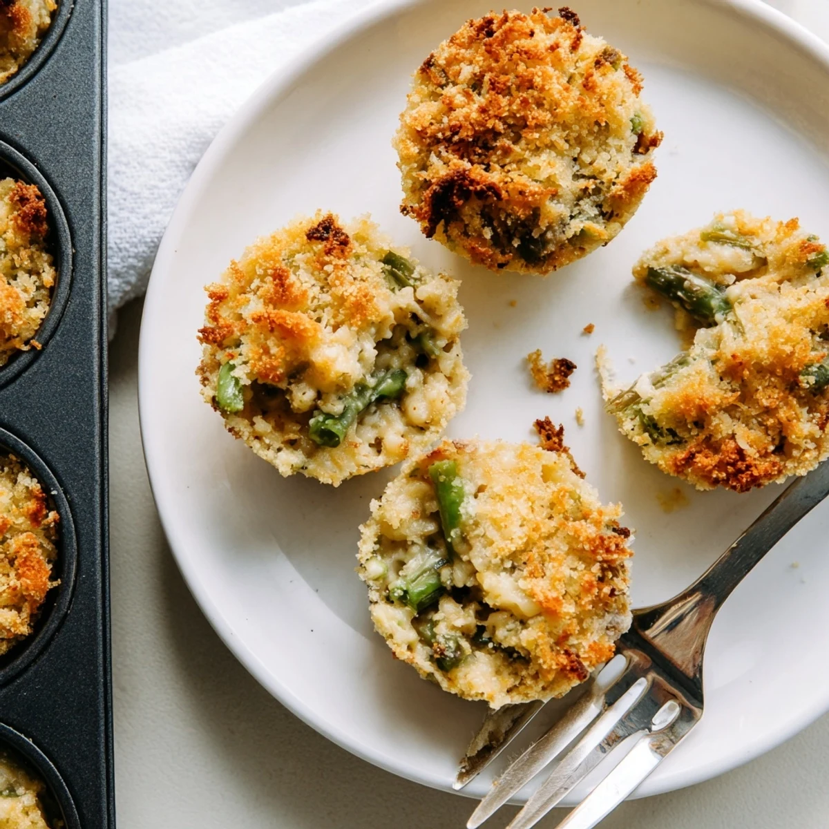 Individual muffin tin portions of Garlic Parmesan Green Bean Casserole Cups featuring tender crisp green beans