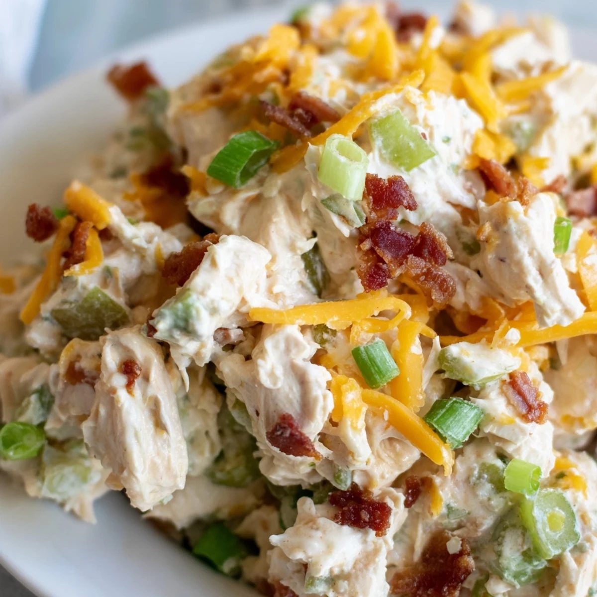 Creamy Jalapeno Popper Keto Chicken Salad topped with crispy bacon crumbles and fresh jalapeno bits