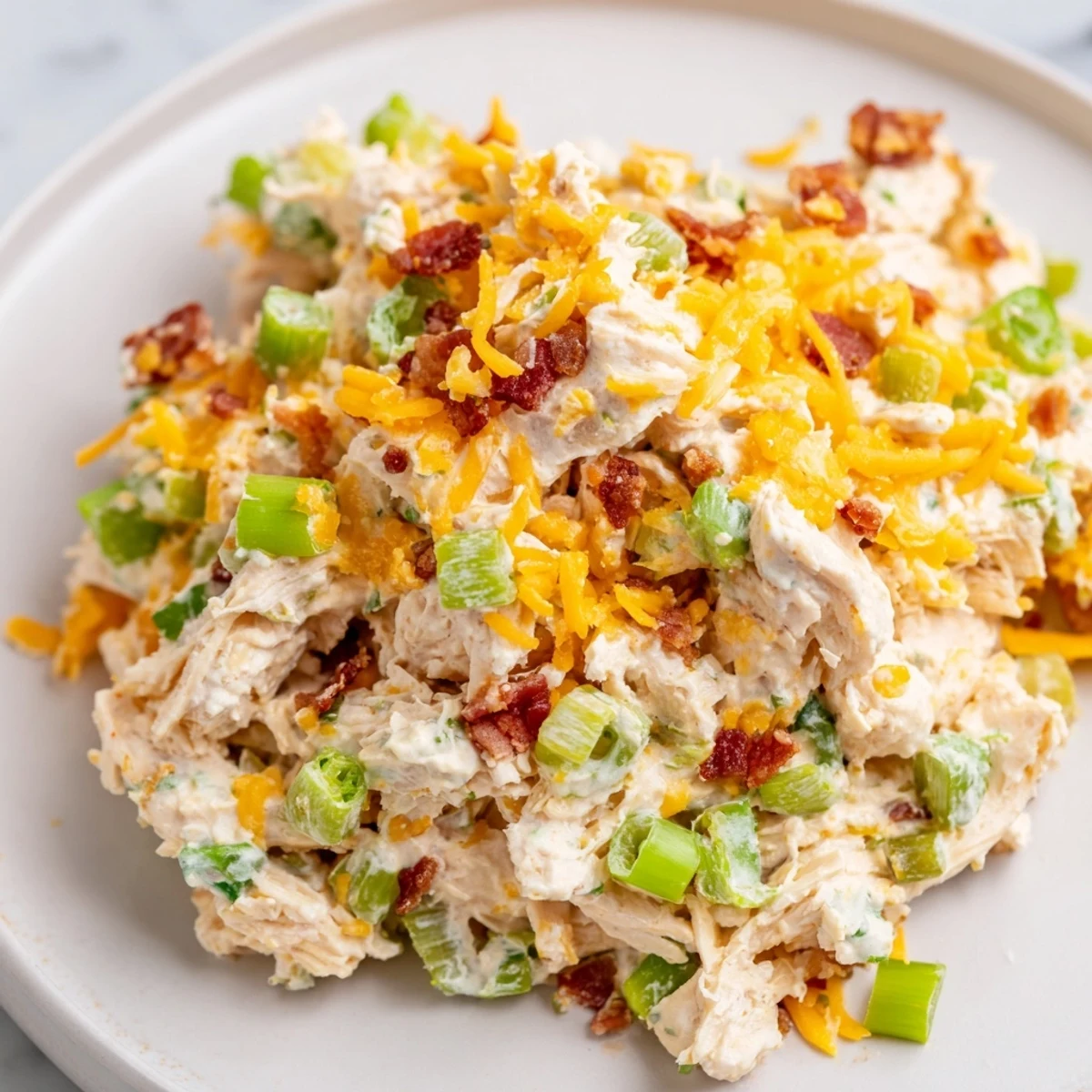 Spoonful of spicy Jalapeno Popper Keto Chicken Salad loaded with cheddar cheese and bacon
