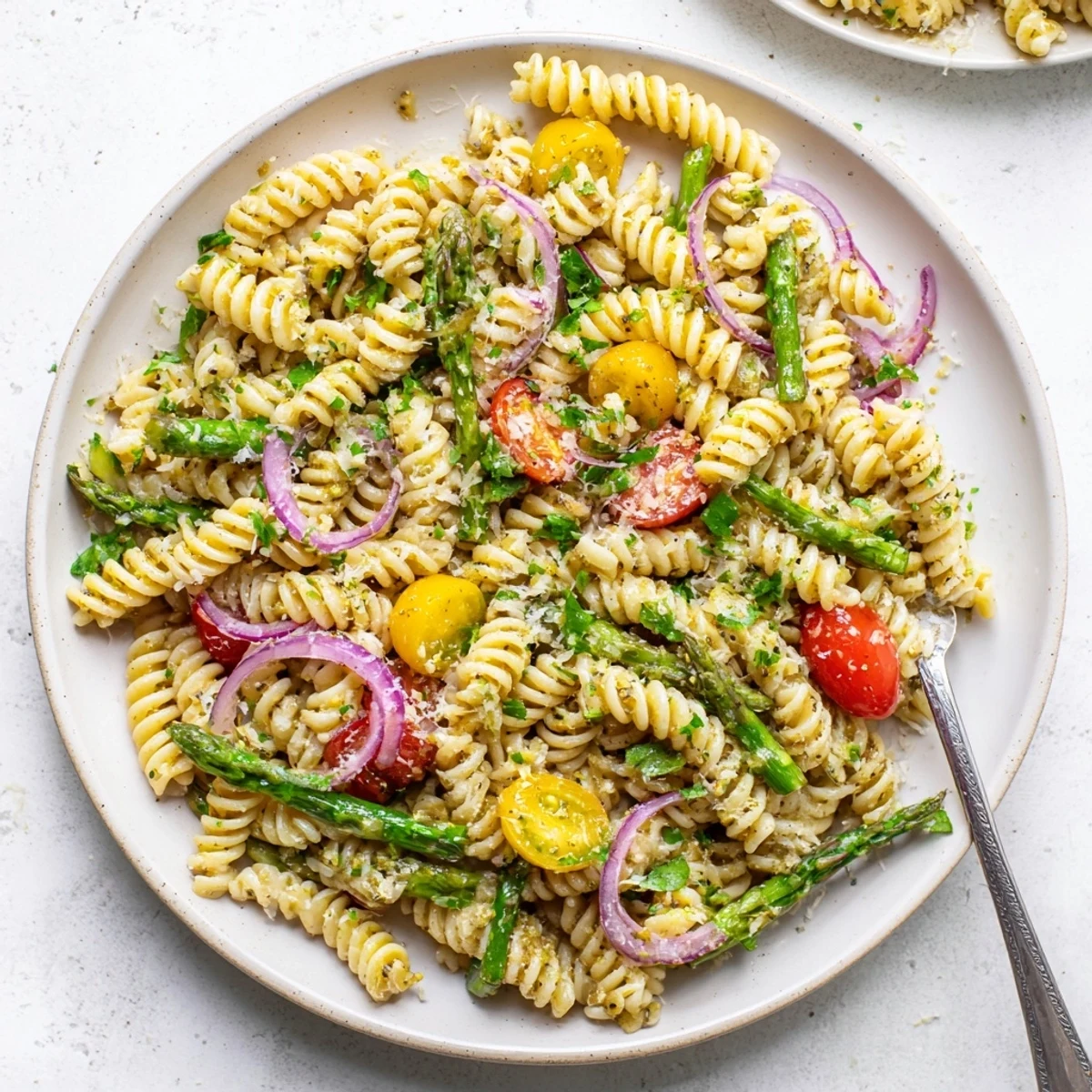 Al dente pasta mingled with tender asparagus spears and zesty lemon herb dressing for spring gatherings
