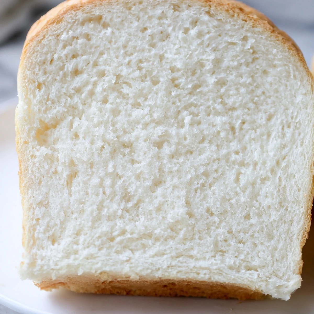 Golden homemade Amish white bread loaf fresh from oven with soft pillowy texture