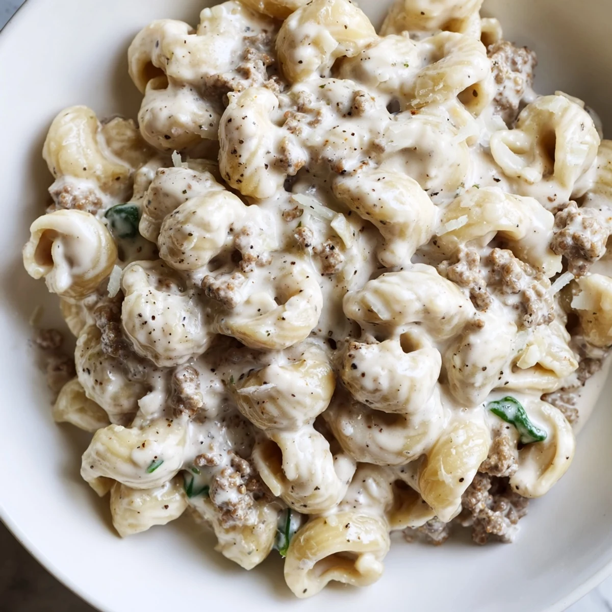Tender ground beef and spinach coated in rich creamy high protein beef pasta sauce