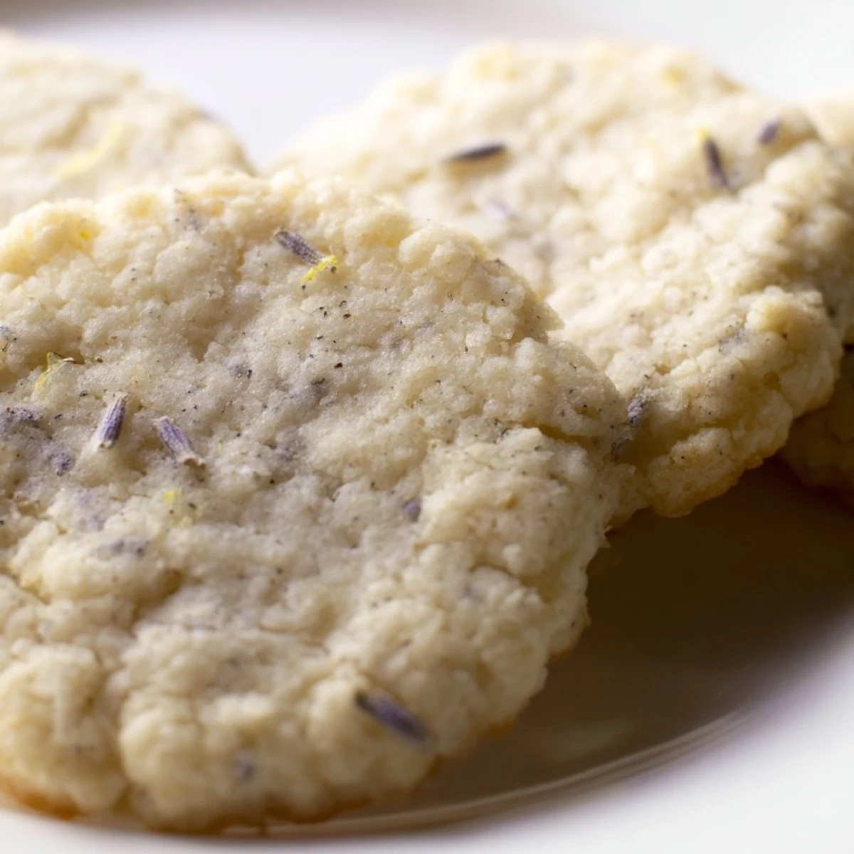 Soft Lemon Lavender Cookies with cracked surfaces and delicate purple specks throughout