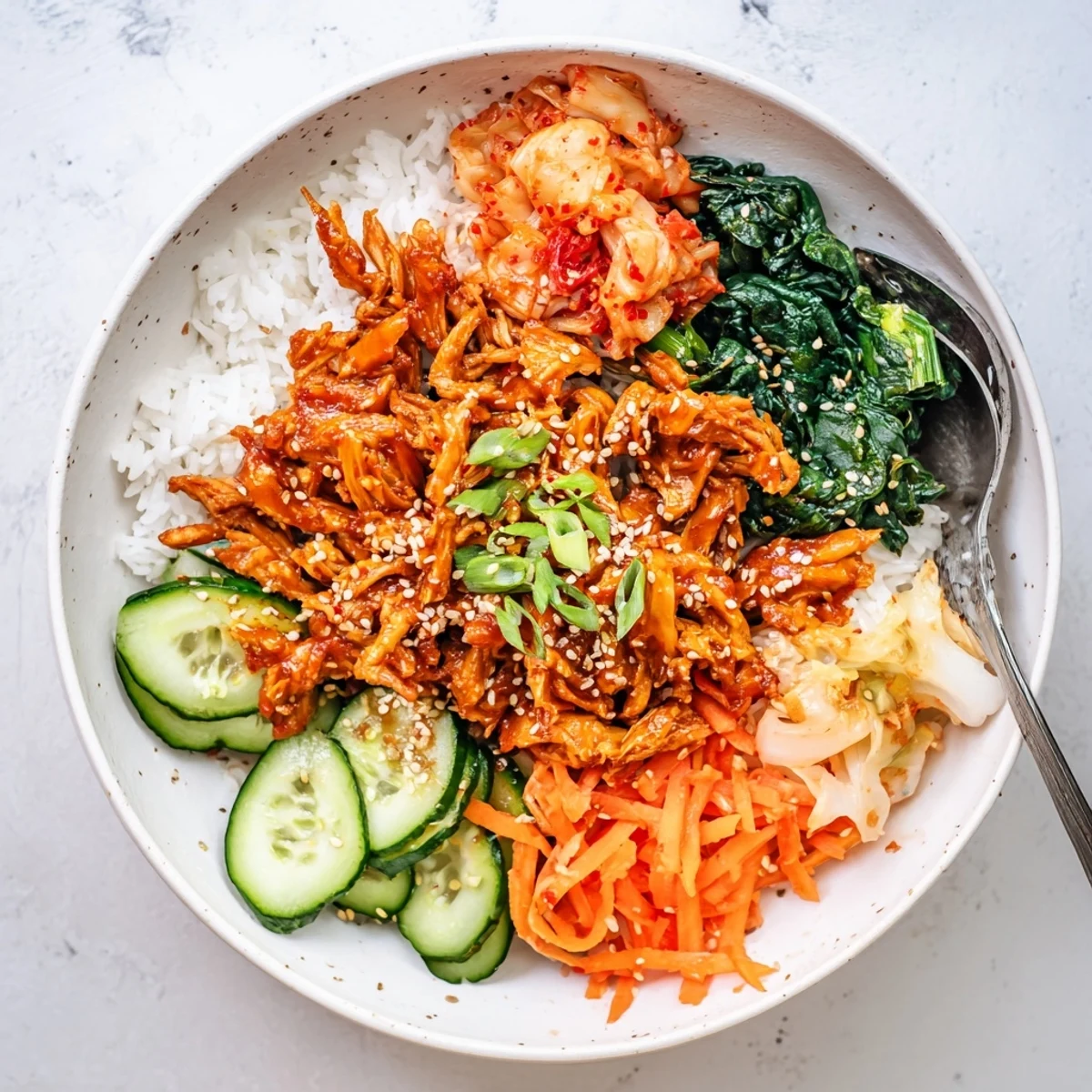 Golden crispy tofu bulgogi bowl topped with vibrant veggies, kimchi, and toasted sesame seeds.