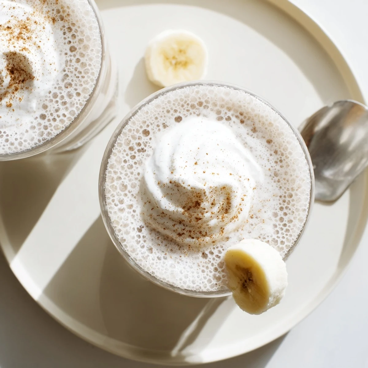 Refreshing Vanilla Banana Shake blended with maple syrup, served cold for breakfast