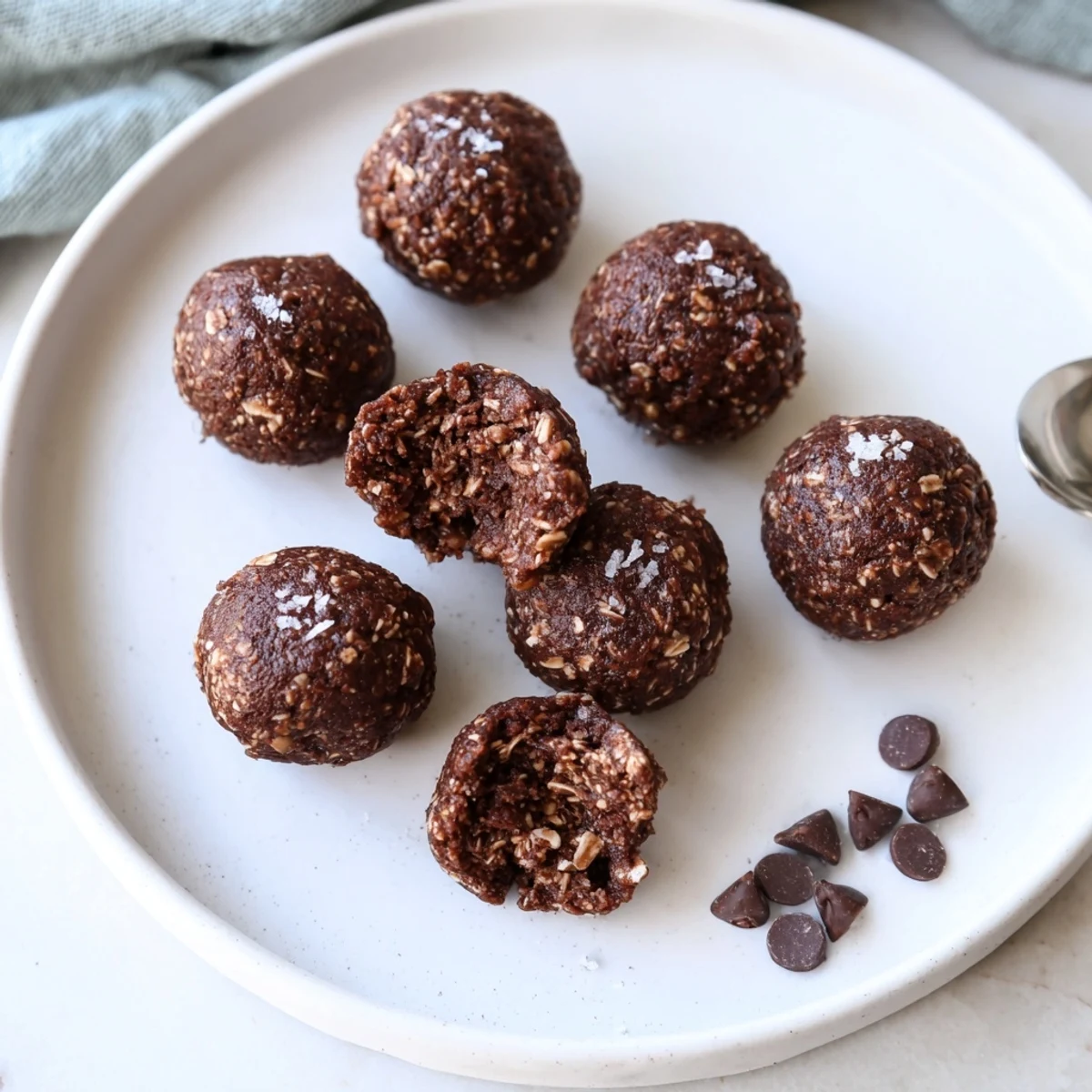 Stacked Brownie Protein Bites on plate, perfect post-workout chocolate snack.