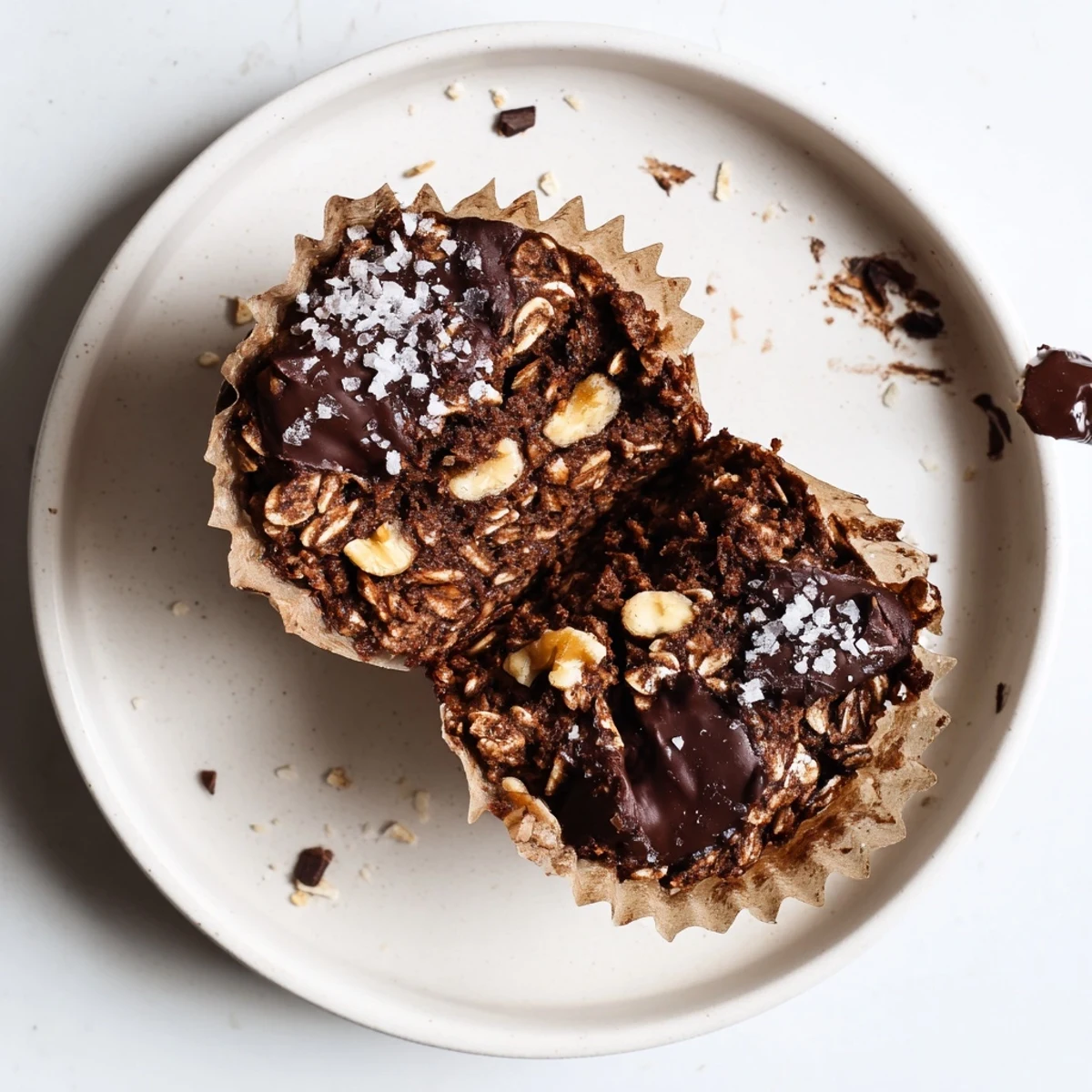 Close-up of Decadent Dark Chocolate Oatmeal Cups in paper liners, gooey.