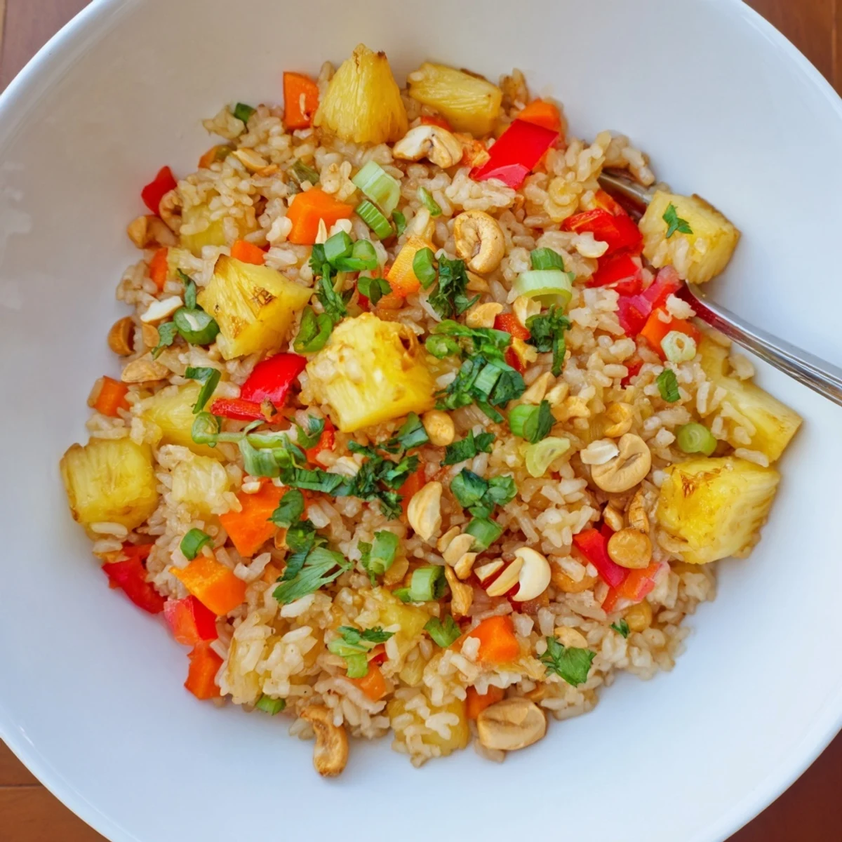 Colorful Pineapple Rice sizzling in a wok, sweet-tangy aroma, lime wedges