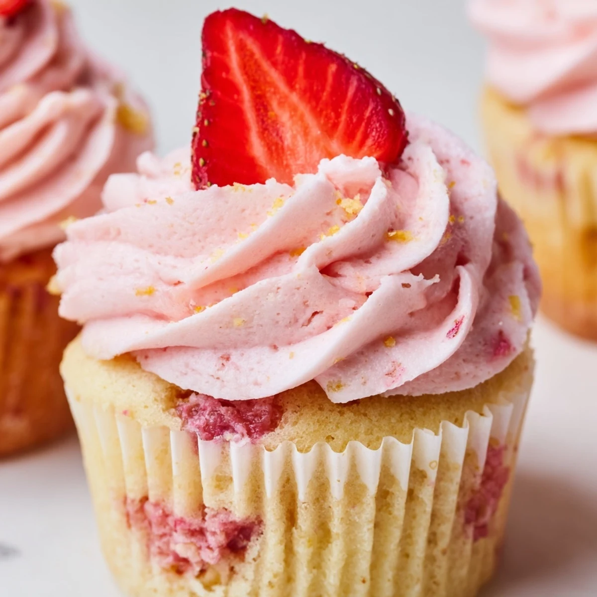 Light and fluffy strawberry lemonade cupcakes with zesty lemon flavor and swirled buttercream frosting