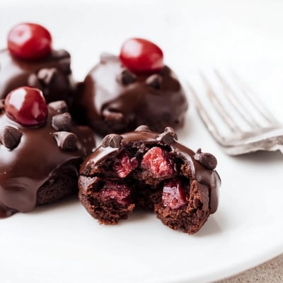 Delicious Chocolate Cherry Brownie Bites cooling on a wire rack, topped with smooth, shiny ganache and ready for an elegant dessert platter.